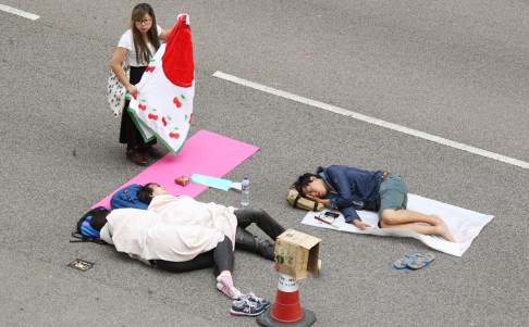 Protesters sleep on blankets on the road in Admiralty. Photo: Dickson Lee
