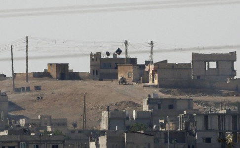 A black flag belonging to the Islamic State is seen flying in Kobani. Photo: Reuters