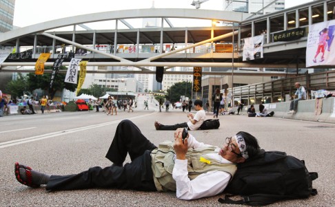 A protester rests on the road in Admiralty. Photo: Edward Wong