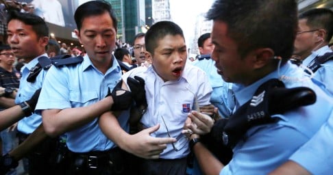 Day six: A student is led away after he was attacked by anti-Occupy demonstrators in Mong Kok.