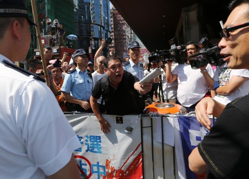 Day 14: A visibly angry man calls for the protesters in Mong Kok to go home so businesses there can go back to normal.