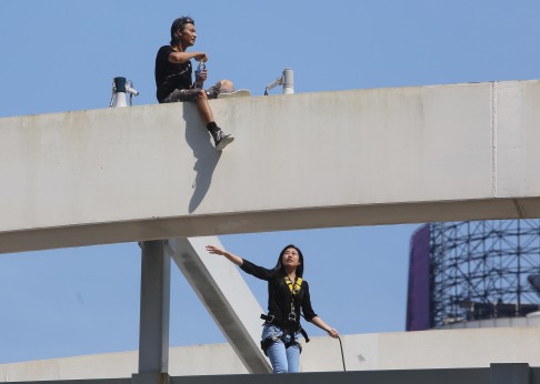 Day eight: A man opposing the Occupy movement threatens to jump off a bridge near the government headquarters in Admiralty unless the protests end. In the end, he was talked down to safety.