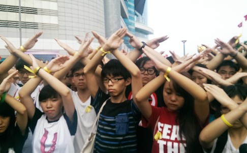 Day four: Joshua Wong Chi-fung, convenor of the student activist group Scholarism, and others turn their backs at a flag-raising ceremony on National Day in Wan Chai.