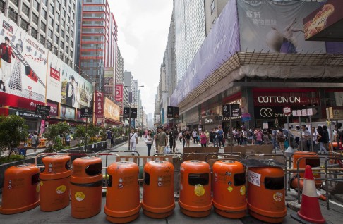 The front line barricade of Occupy Mong Kok is made out of orange trash cans and bus stops on Nathan Road. Photo: EPA