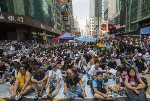 Pro-democracy protesters gather to listen to speeches at the usually busy intersection of Argyle Street and Nathan Road. Photo: EPA