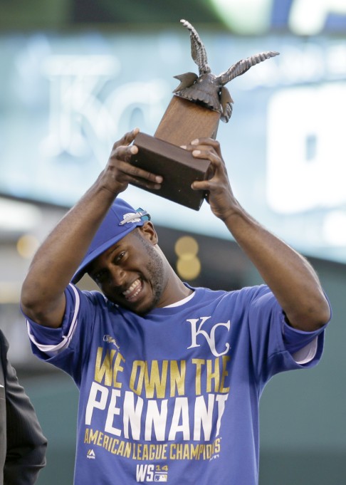 The Royals' Lorenzo Cain holds up the MVP trophy. Photo: AP