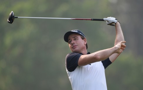 Brett Rumford watches his shot head up the fairway in the first round of the Hong Kong Open. The Australian carded a 72. Photo: Richard Castka   