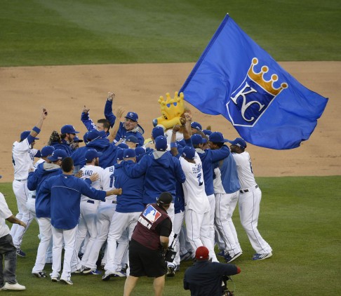Kansas City players rush the field to celebrate after the final out. Photo: MCT
