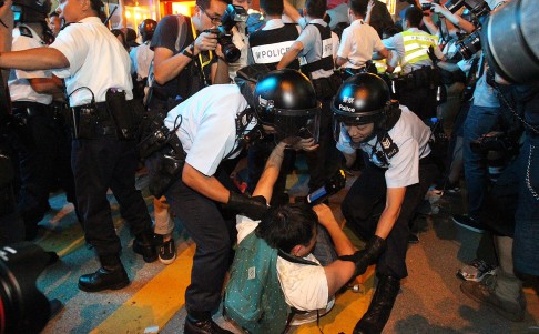 Police remove a protester from Nathan Road. Photo: May Tse