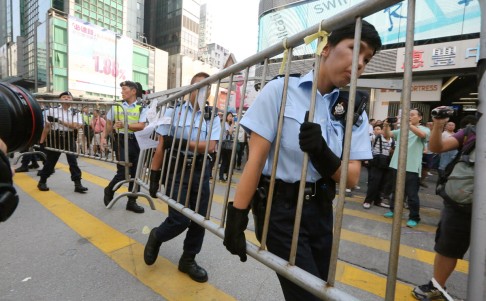 Police move the barricades aside. Photo: Felix Wong