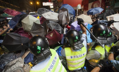 Police used pepper spray and batons to try and disperse the crowds last night. Some 9,000 people massed in Mong Kok, according to authorities. Photo: EPA