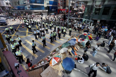 Hong Kong's riot policemen stand guard as pro-democracy protesters re-occupy Argyle Street. Photo: EPA