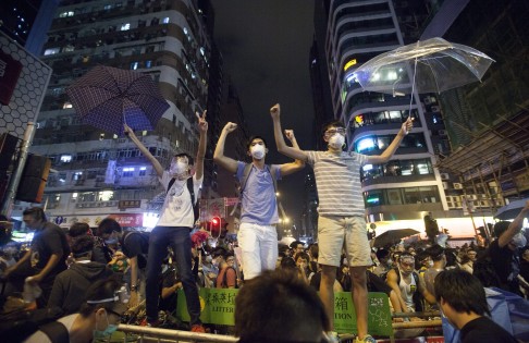 Pro-democracy protesters are seen celebrating after the Hong Kong police lost control of Mong Kok. Photo: EPA