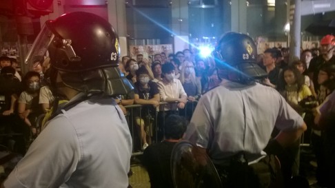 Police stand off against demonstrators shortly after midnight on Sunday. Photo: SCMP