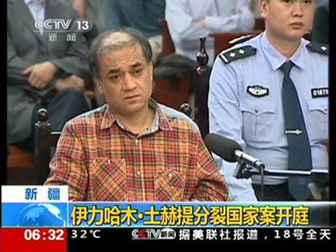 Uighur academic Ilham Tohti sits during his trial on separatism charges in Urumqi, Xinjiang region. Photo: CCTV