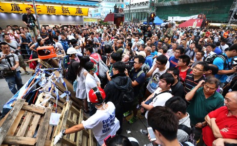 Protesters try to protect barricades at Mong Kok. Photo: K. Y. Cheng
