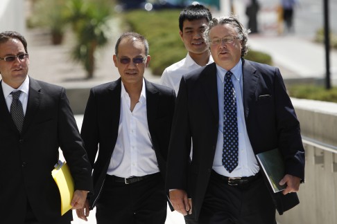 Paul Phua, second from left, and his son Darren, third from left, walk to a courthouse in Las Vegas with their attorney Richard Schonfeld in August. Photo: AP