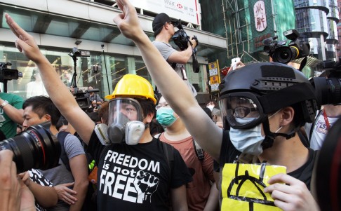 Protesters wear masks in case pepper spray and tear gas is fired while facing off with bailiffs and police. Photo: Sam Tsang