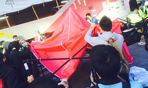 Protesters take down a tent on Argyle Street on Tuesday morning. Some moved supplies to the Nathan Road camp. Photo: Ernest Kao