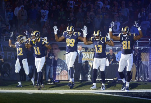 St. Louis Rams wide receiver Stedman Bailey (12), wide receiver Tavon Austin (11), tight end Jared Cook (89), wide receiver Chris Givens (13) and wide receiver Kenny Britt (81) put their hands up to show support for Michael Brown last week. Photo: AP