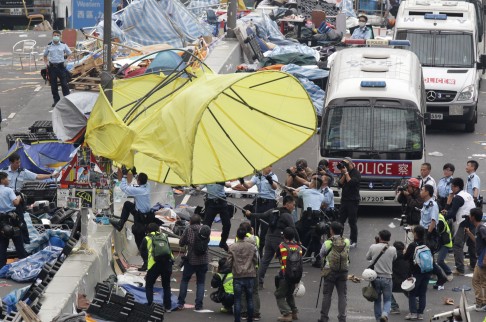 Police and workers took down a giant umbrella that had become a symbol for protesters.