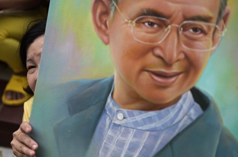 thai_well-wishers_hold_portraits_of_king_bhumibol_adulyadej_.jpg