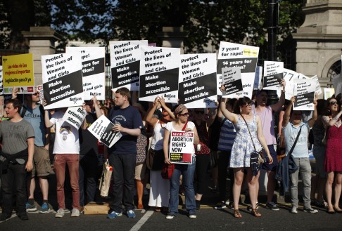 Pro-Choice supporters hold placards in front of the gates of the Irish Parliament building in Dublin last year. Photo: AFP