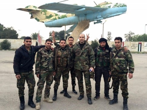 Pro-regime gunmen pose at an airport (above). Photo: AFP