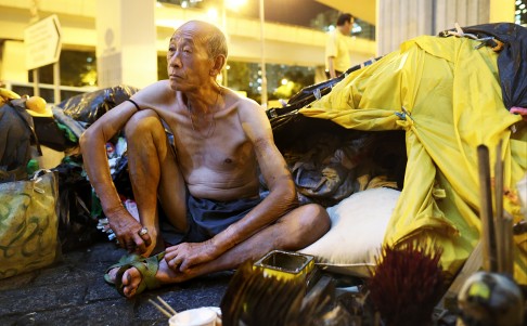 A topless man rests in his tent made of clothes under the Ferry Street Flyover. Photo: Dickson Lee
