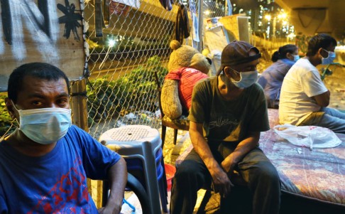 Homeless people wear masks to protect themselves from polluted air under the flyover. Photo: Dickson Lee