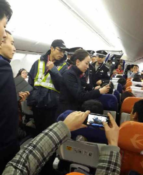 Police are investigating 25 passengers after their plane's emergency exits were forced open.