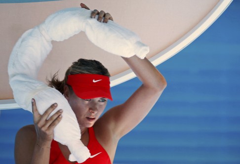 Maria Sharapova takes an ice towel off her neck. Photo: AP