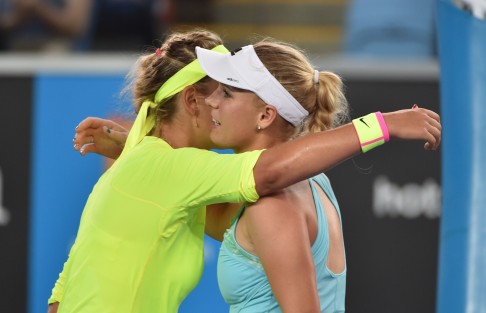 Victoria Azarenka hugs Caroline Wozniacki after beating the eighth-seeded Dane her in their women's singles match. Photo: AFP 