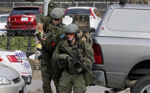 Armed officers approach Parliament Hill following a shooting incident in Ottawa in October last year. Photo: Reuters