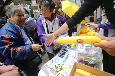 Yellow umbrellas from Hong Kong's Occupy Movement are passed out to marchers. Photo: Felix Wong