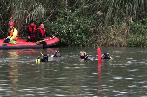 Divers continue to look for missing passengers of TransAsia Airways Flight 235 in the Keelung River in Taipei. Photo: AP