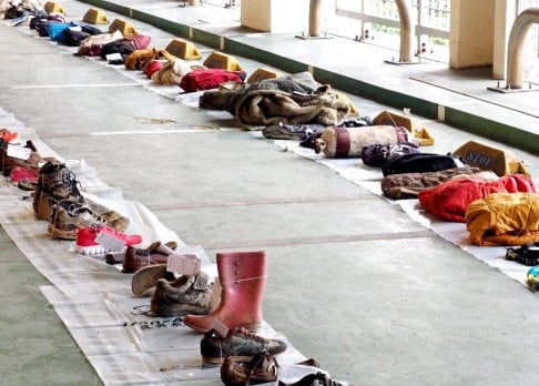 Shoes and belonings recovered from the crashed TransAsia Aiways plane and crash site, are displayed for identification by victims' family members. Photo: EPA