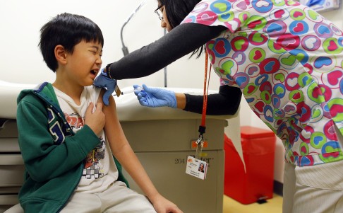 A child gets an influenza shot. The vaccine production process begins with the collection of clinical specimens from patients with influenza symptoms. Photo: Reuters