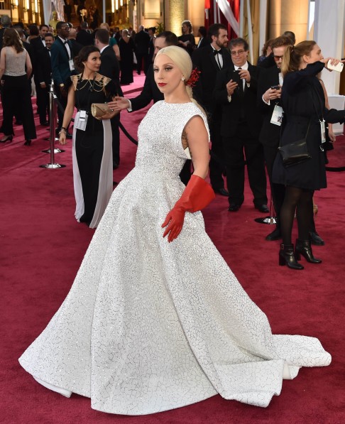 Lady Gaga wore a space-age sparkling white and silver Azzedine Alaia gown with a full skirt. Photo: AFP