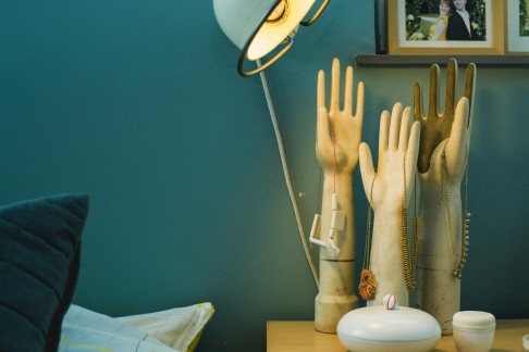 Vintage Jieldé lamp, hand moulds for rubber gloves hold necklaces that are handmade by her husband, Jesse. Photos: Amanda Kho