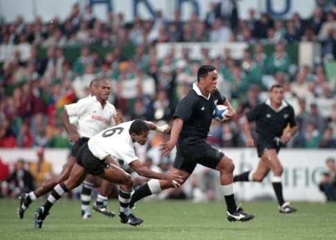 PHOTO 28: New Zealand's Jonah Lomu slips past Fiji's Waisale Serevi in the 1995 Cup final.