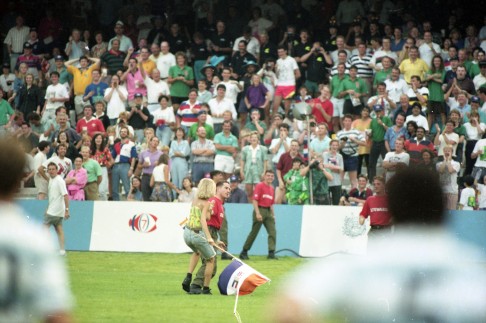 PHOTO: 15: A South African fan is escorted from the pitch in 1993.