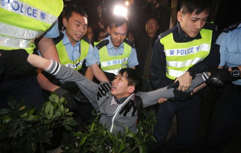 Police arrest a protester during the anti-parallel trading rally outside Tuen Mun West Railway MTR station. Photo: Felix Wong