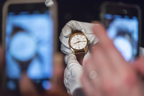 People take smartphone photos of the new Globemaster chronometer, introduced by Omega during a show at Baselworld in Switzerland. Photo: EPA