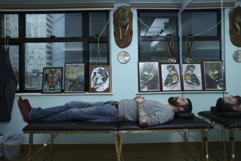 Rob Kelly searches for inspiration at his tattoo parlour.