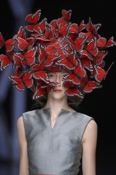 Butterfly head-dress of hand-painted turkey feathers from McQueen's 2008 spring-summer show La Dame Bleu. 