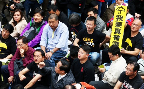 Pan-democrat and protesters sit at protest site while police removed barricades and tore down tents at protest site in Admiralty in December, 2014. Photo: K.Y. Cheng