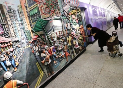 A passenger inspects an art installation at Sai Ying Pun MTR station. Photo: David Wong
