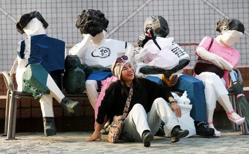 A visitor poses with an exhibition of Ju Ming sculptures at the Museum of Art. Photo: Edward Wong