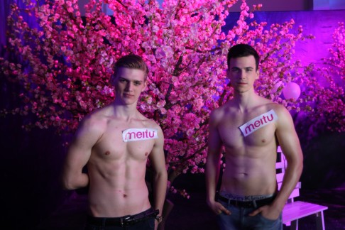 Two male models pose for photos at the Meitu M4 launch event in Beijing on April 8, 2015. Photo: Simon Song 